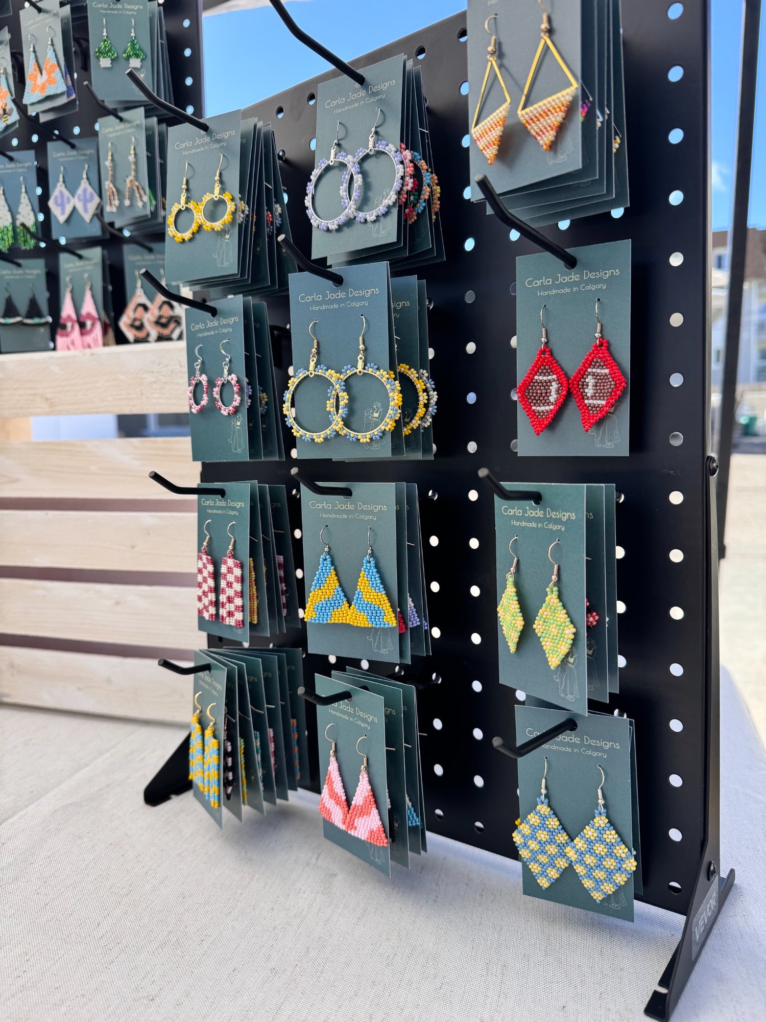 Carla Jade Designs colourful handmade earrings displayed at a Calgary market